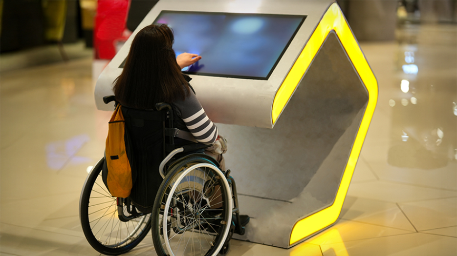 A person in a wheelchair uses an electronic navigation device